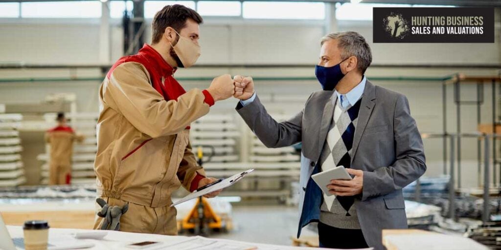 Business Makes Money article feature image. 2 men fist bump in agreement