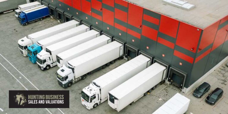 Logistics Businesses In Demand Article Feature Image of A Warehouse Surrounded By Trucks