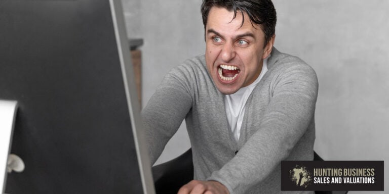 How to Buy a Business Feature Image Angry Man In Front of a Computer