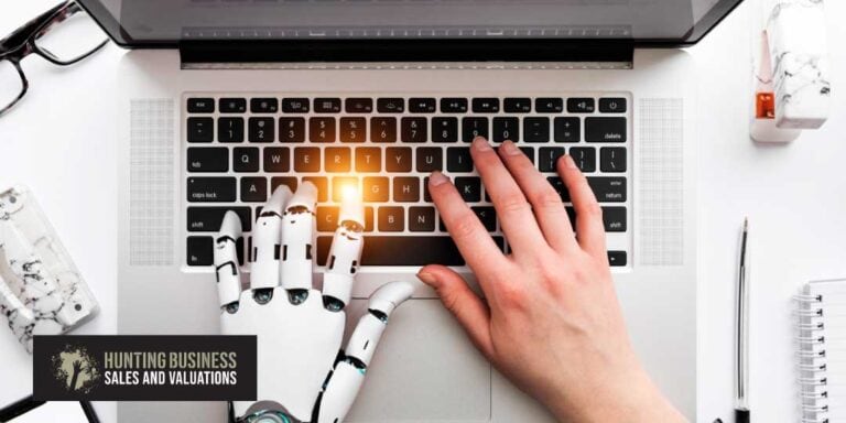 Is AI Our Nemesis Feature Image Robotic hand next to a real hand on a keyboard